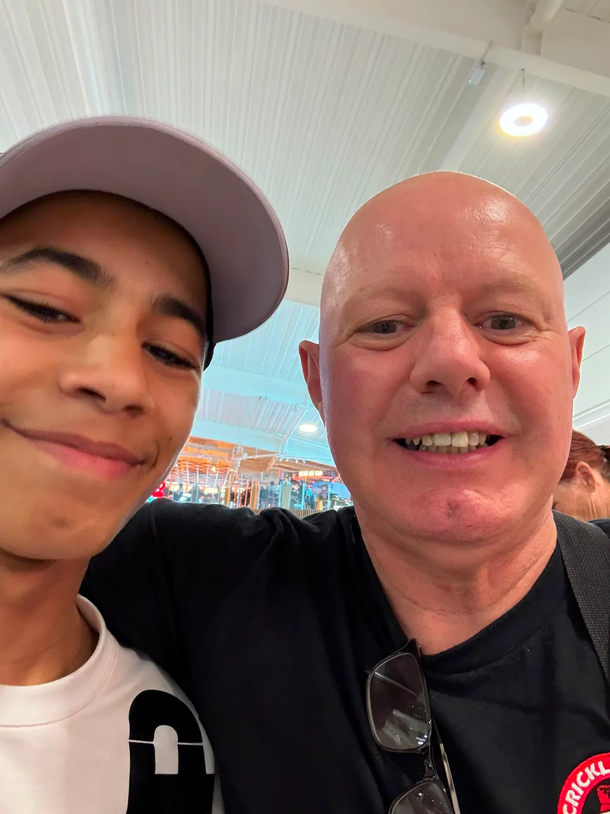 A young boxer taking a selfie with his coach